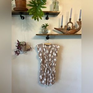 Ruffle sleeve, taupe romper with a tie waist.